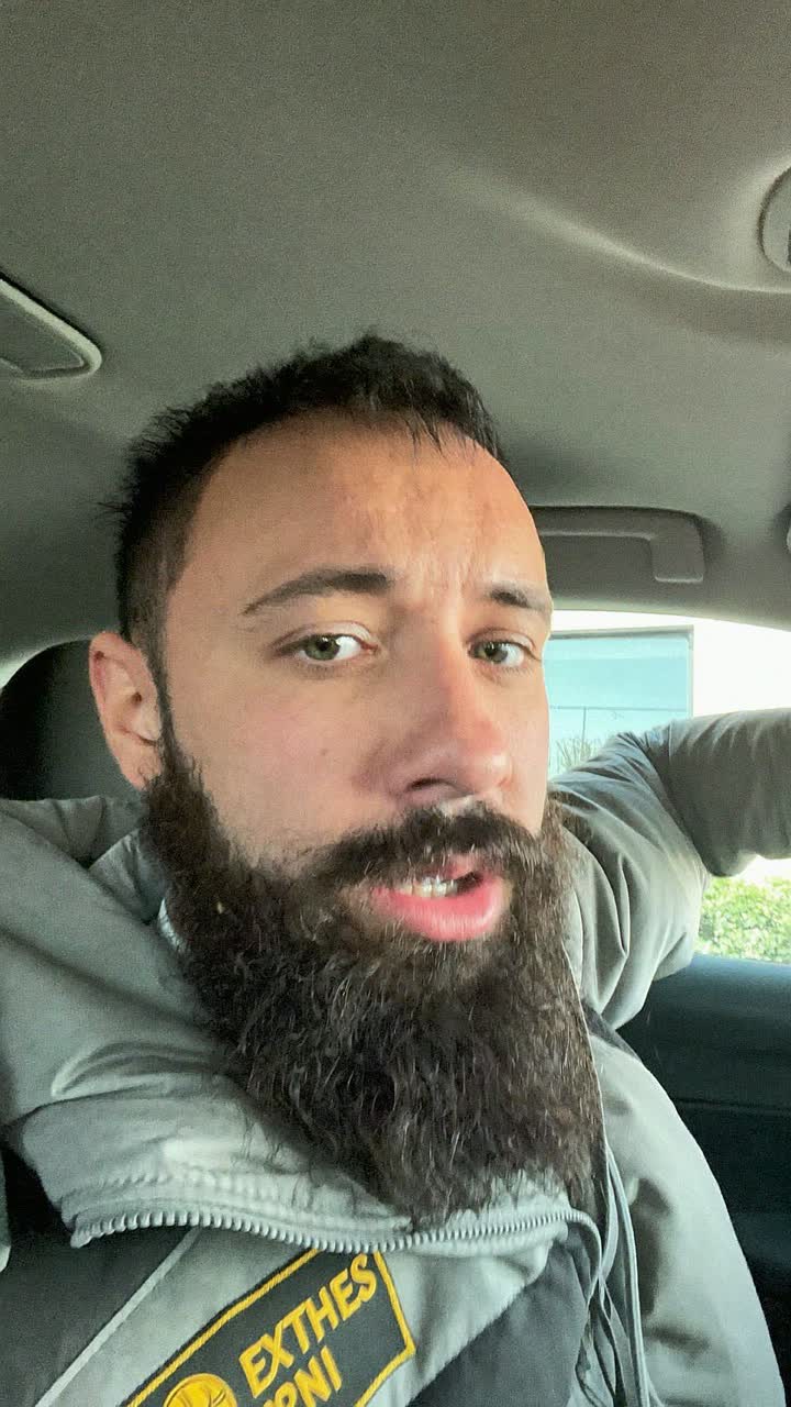 Ahmed, 36-year-old Egyptian man, full dark beard, wearing a delivery-driver jacket