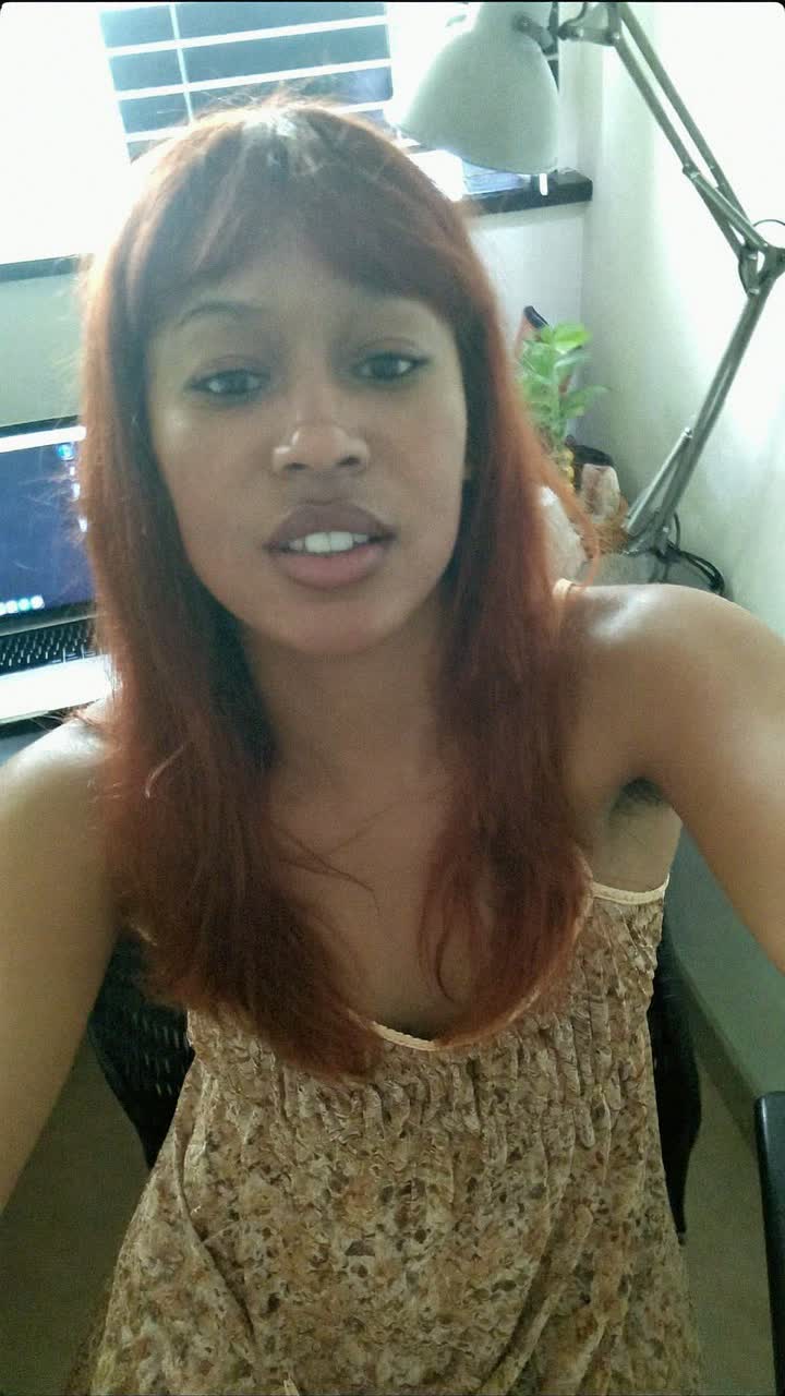 Akosua, 31-year-old Ghanaian woman, auburn hair with curtain bangs, wearing a flowy floral sundress