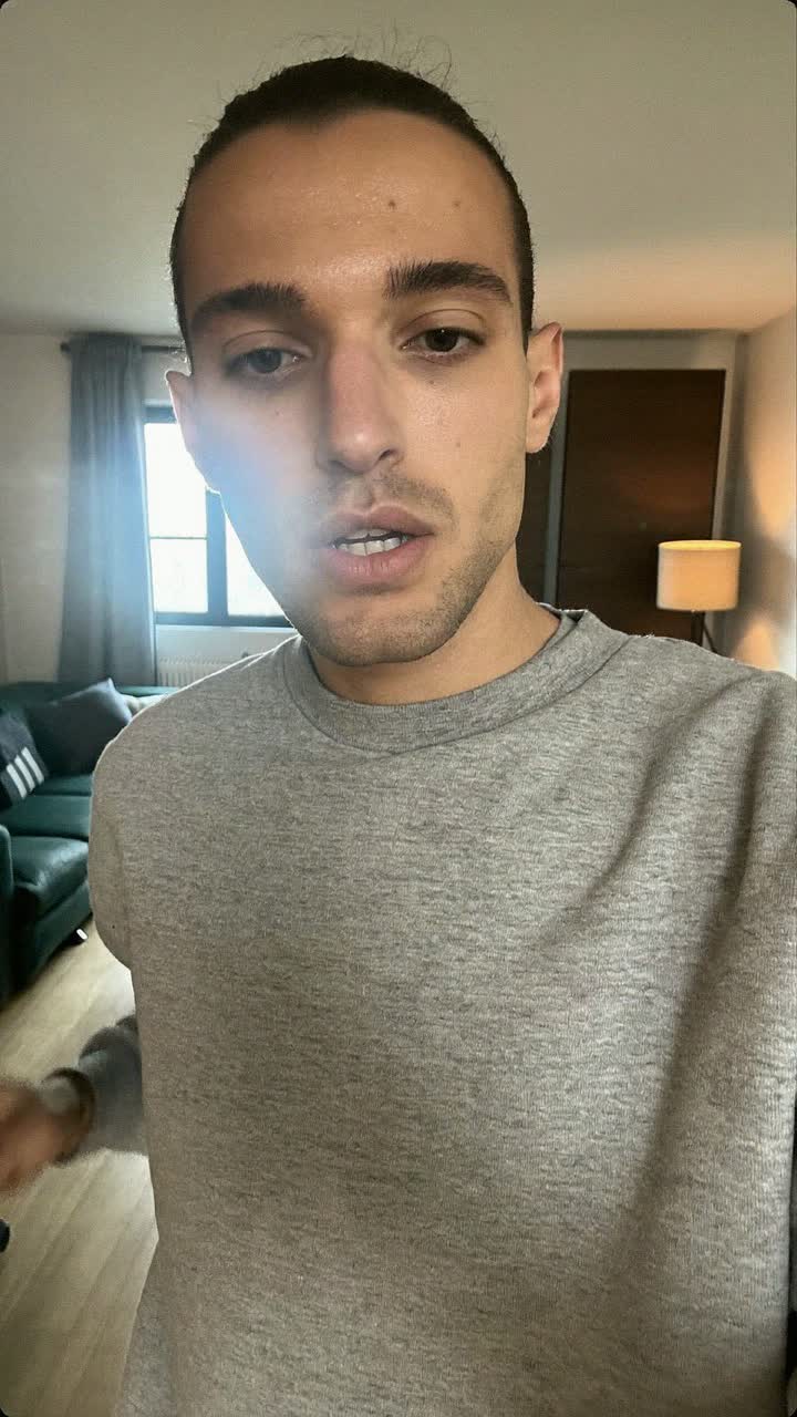 Álvaro, 22-year-old Spanish man, slicked-back hair, wearing a grey crewneck sweatshirt
