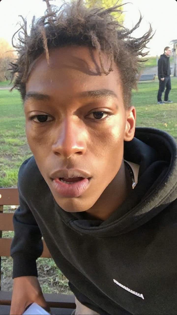 Andre Thomas, 24-year-old Afro-Caribbean man, clean-shaven with tousled hair, wearing a black hoodie