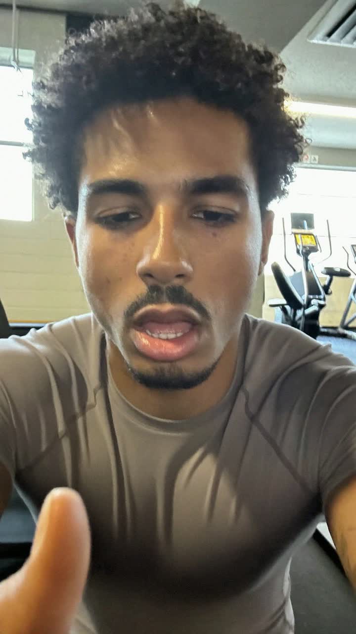 Emeka, 22-year-old Nigerian man, curly top, wearing a fitted training tee