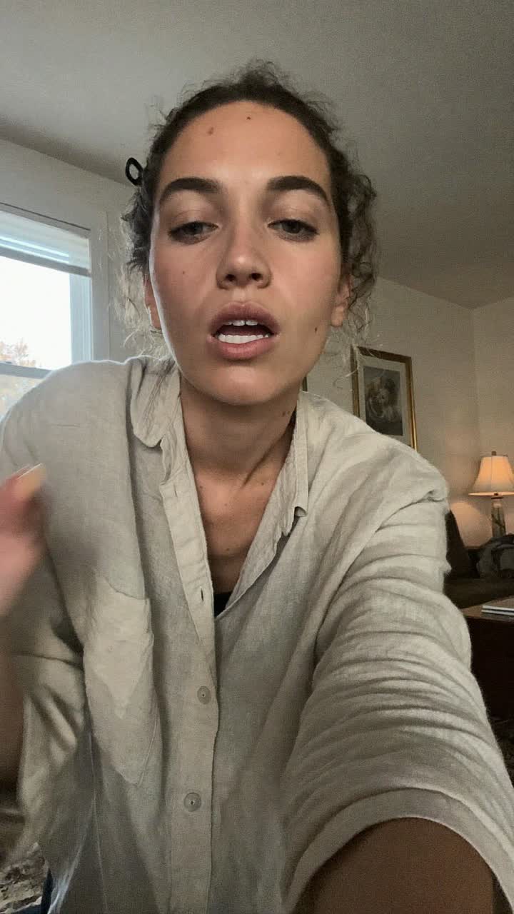 Kate, 33-year-old white American woman, loose curls with a claw clip, wearing a linen button-down