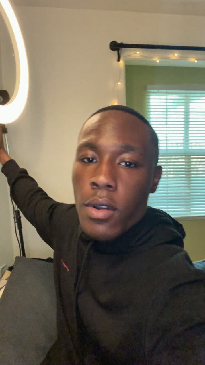 Kwame, 22-year-old Ghanaian man, short fade haircut, wearing a black hoodie