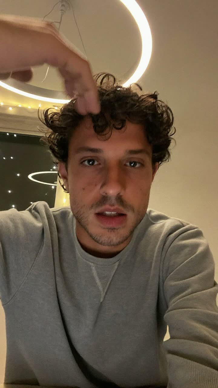 Lars, 30-year-old Scandinavian man, curly top, wearing a grey crewneck sweatshirt
