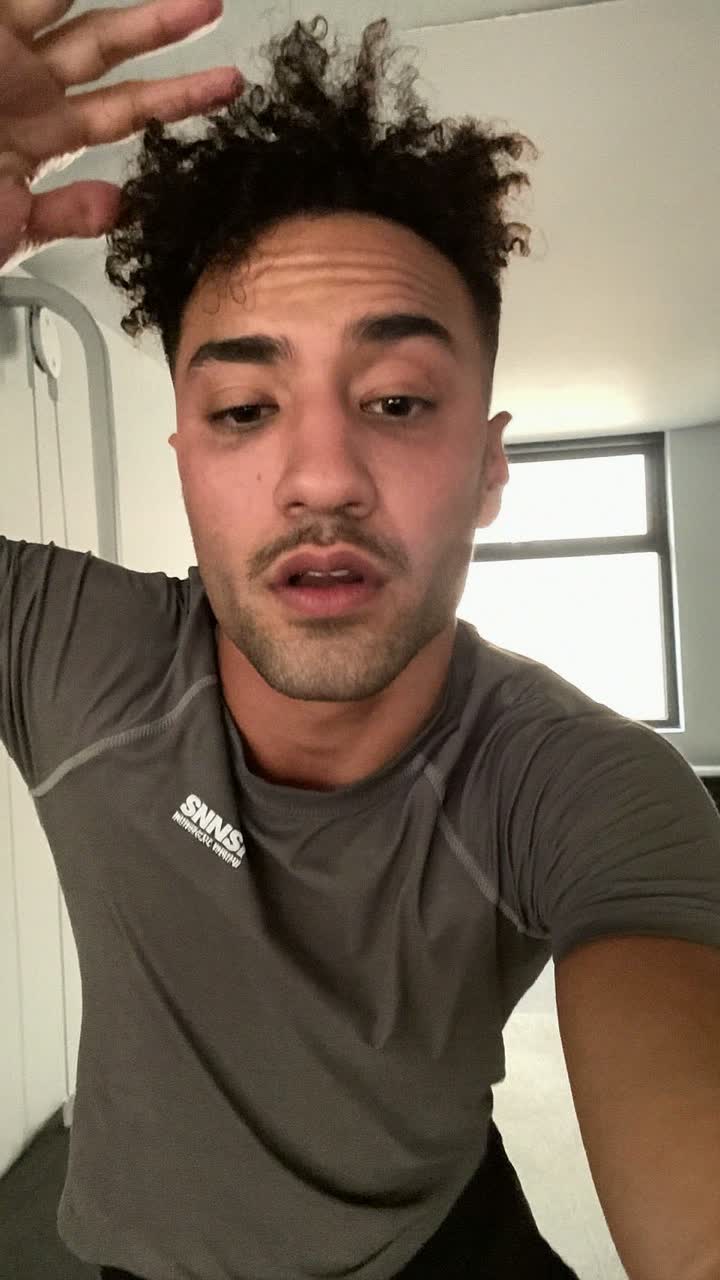 Lucas, 33-year-old Brazilian man, curly top, wearing a fitted training tee