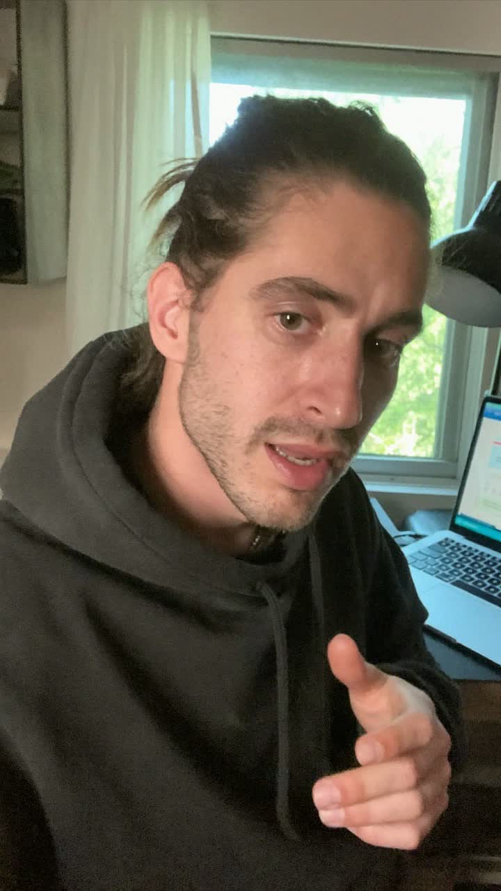 Tyler, 36-year-old white American man, man bun, wearing a black hoodie