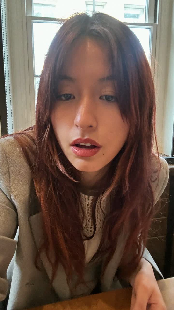 Valentina, 21-year-old Mexican woman, auburn hair with curtain bangs, wearing a blazer over a tee