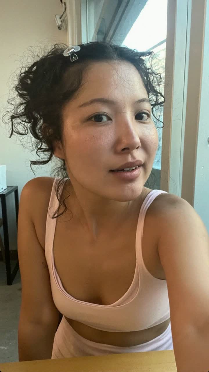 Yuna, 42-year-old Korean woman, loose curls with a claw clip, wearing a soft pink matching lounge set